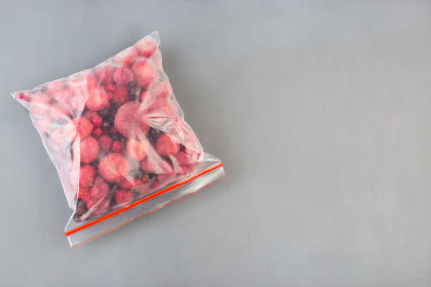 istock Frozen berries in the plastic bage, raspberry, strawberry, cranberry and black currant, horizontal, copy space,  top view 1288843764