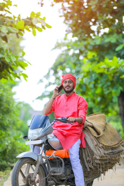 istock Young indian farmer talking on mobile phone 1288844201