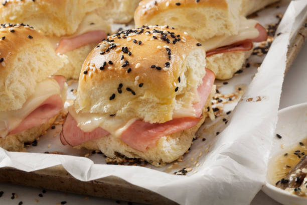 istock Baked Ham And Swiss Sliders on White Tray Buns 1288845582