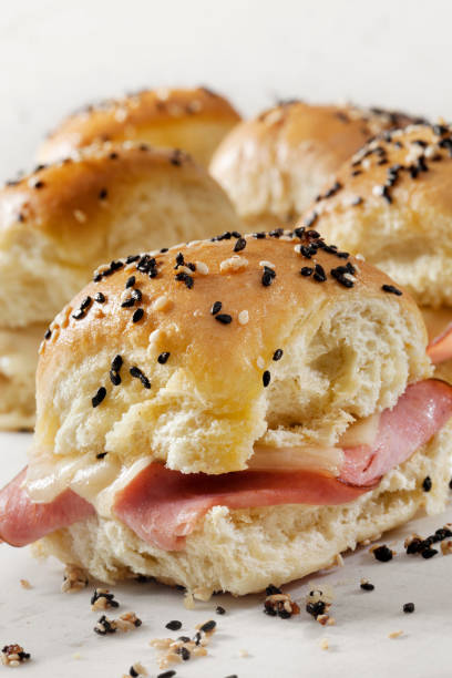 istock Baked Ham And Swiss Sliders on White Tray Buns 1288845585