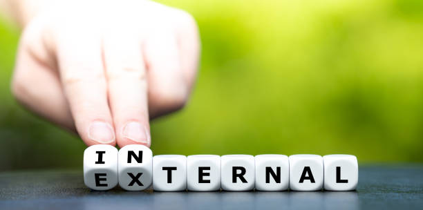 istock Hand turns dice and changes the word external to internal. 1288845642