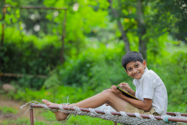 istock Cute Indian little child studying at home 1288847349