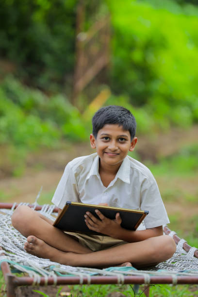 istock Cute Indian little child studying at home 1288847390