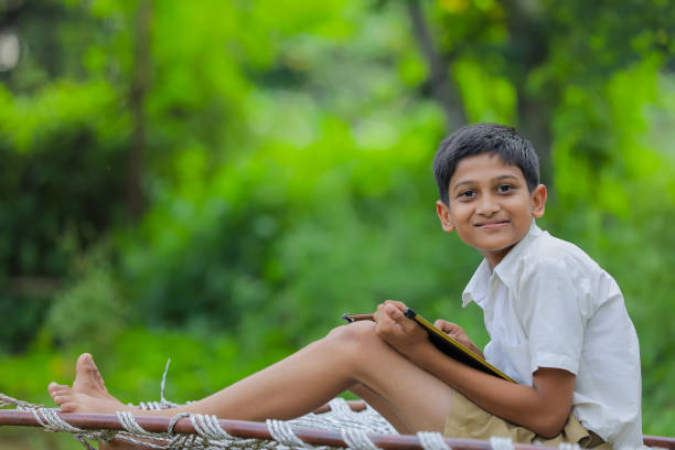 istock Cute Indian little child studying at home 1288847407