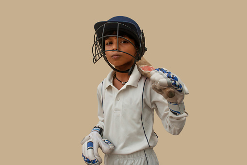 Confident boy wearing cricket helmet and ready for playing