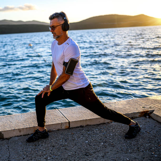istock Man stretching on the shores 1288850242