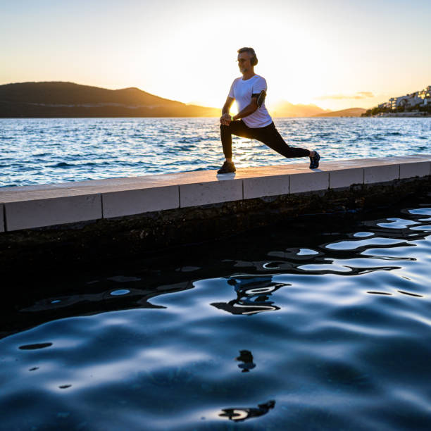 istock Man stretching on the shores 1288851853