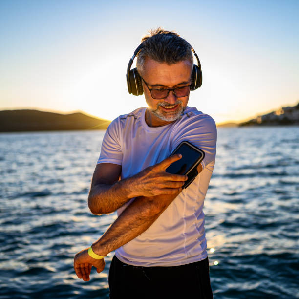 istock Mature man tuning up for run 1288852783