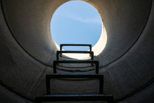 View from the sewer to the sky Germany: View from the sewer through an open manhole cover into the sky manhole stock pictures, royalty-free photos & images