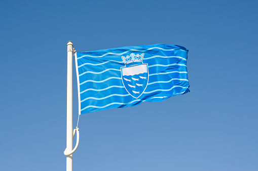 Sussex Flag flying from the pier at Worthing, West Sussex, England