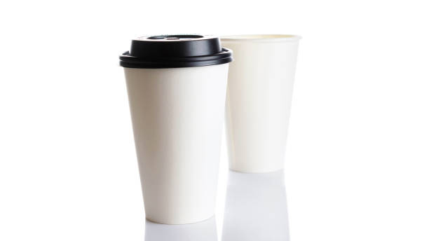 istock White paper cup for hot coffee with black lid isolated on white background. Takeaway blank small tea cup for your design text or banner of brand. 1288854474