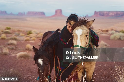 istock Navajo native american woman hugging her beloved horse at the Arizona desert 1288859044