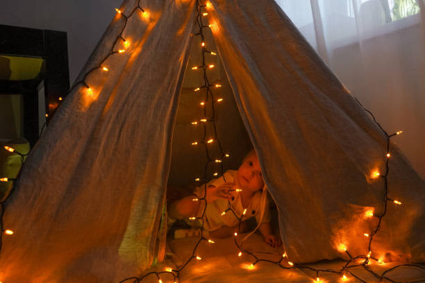 istock Magic tent with garland home, girl inside. 1288859577
