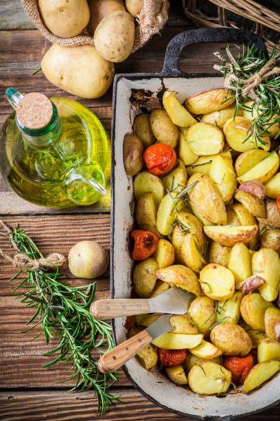 istock Baked potatoes with cherry tomatoes, garlic and rosemary 1288861402