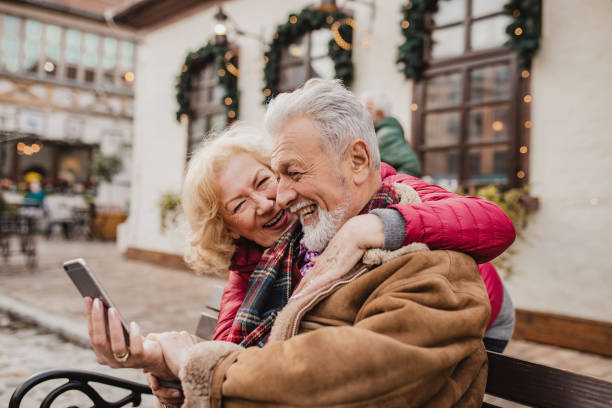 istock Senior couple is using mobile phone outdoors 1288868695