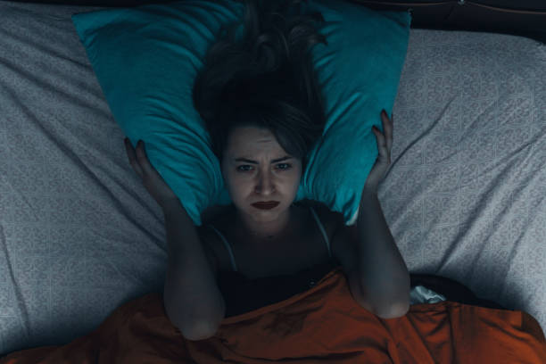 istock Sad Woman Lying On Bed 1288868800
