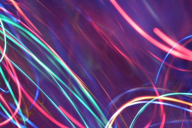 istock Abstract Multicolored Light Motion of Wavy and Round Line Trails Background. Glowing and Bright Neon Colors. 1288871365