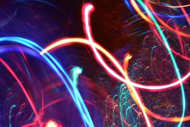 istock Abstract Multicolored Light Motion of Wavy and Round Line Trails Background. Glowing and Bright Neon Colors. 1288871368