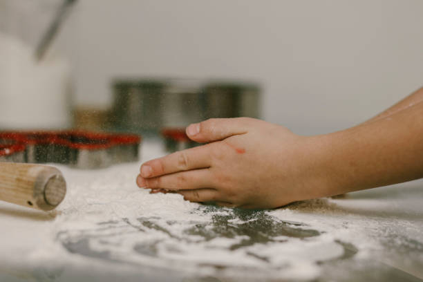 istock a child plays with flour on the table 1288871708