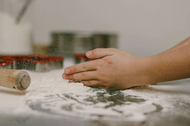 istock a child plays with flour on the table 1288871712