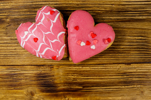 Heart shaped cookies on wooden table. Top view, copy space. Dessert for valentine day