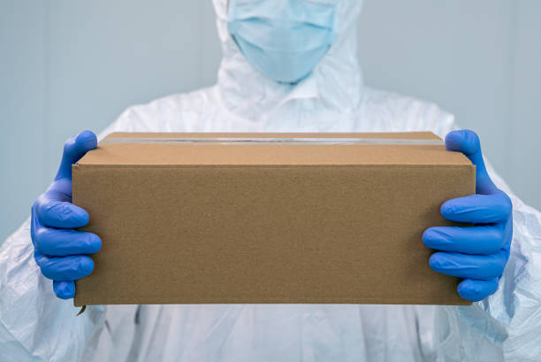 istock A nurse in a protective suit shows a box with both hands in a hospital. Covid 19 1288879010