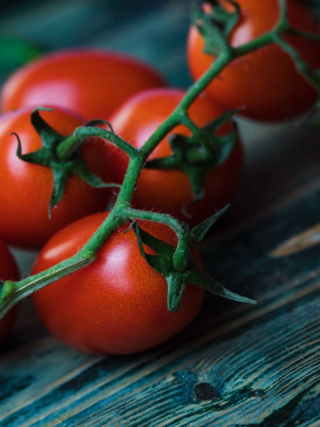 istock Fresh organic cherry tomatoes on wooden background 1288880395