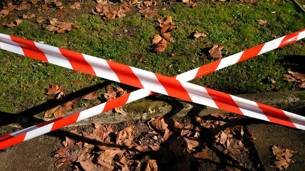 Cross of warning  red and white striped line tape,  trespassing forbidden, hazardous area sign.