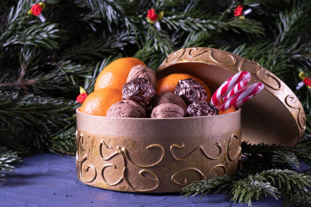 istock nuts, new year spruce branches, sweets in a box on a blue background 1288882418