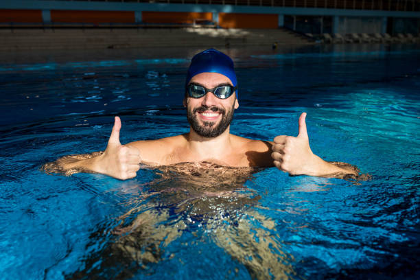 istock The handsome man in the pool feels great 1288882546