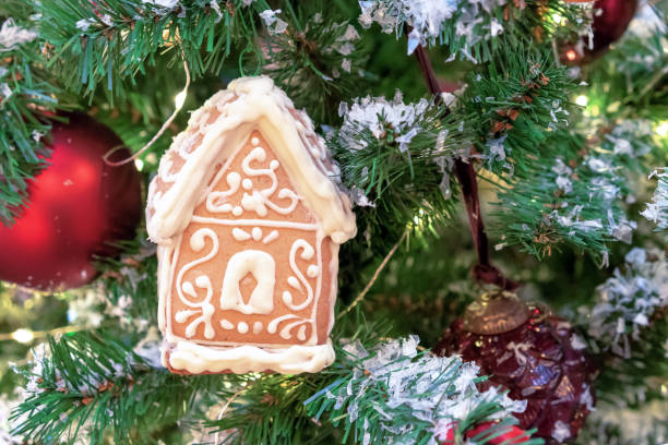 istock Gingerbread house with white icing on the Christmas tree. 1288883465