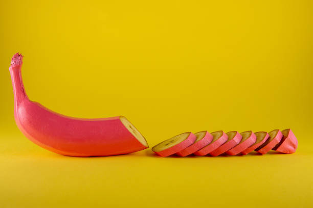 istock Pink banana on yellow background 1288883895