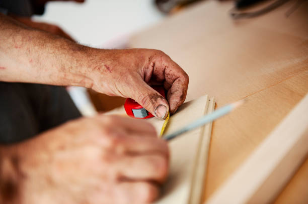 istock Carpenter drawing measurements on a wood 1288888298