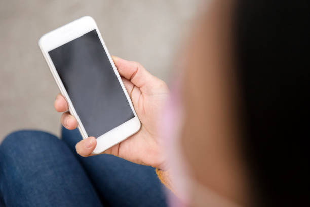 istock Young woman looking at blank smart phone ,copy space 1288888832