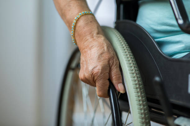 istock Unrecognizable woman sitting in a wheelchair 1288893761