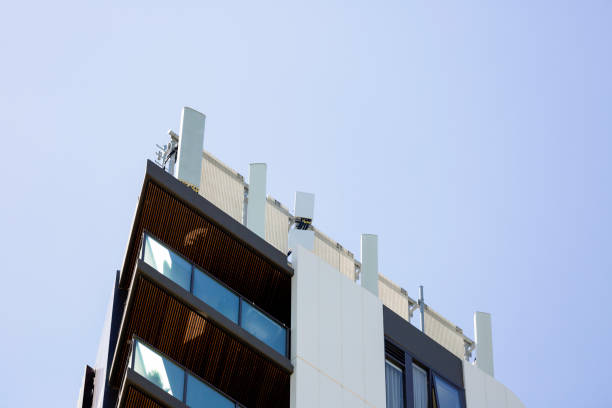 istock Apartment building rooftop cell towers, background with copy space 1288896063