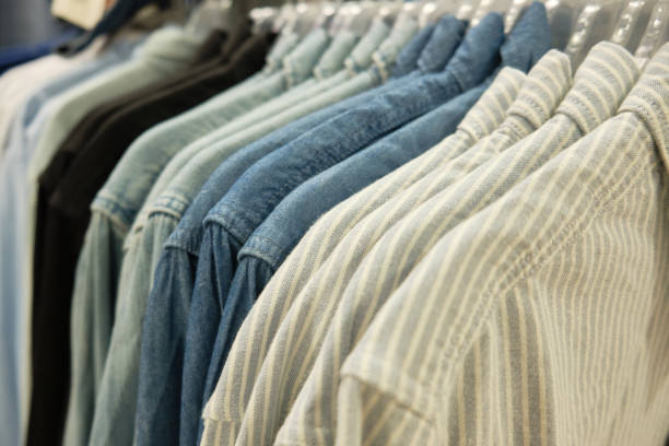 istock Different casual men shirts hang on hanger racks at store 1288899888