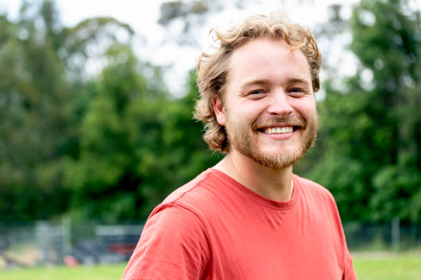 istock Portrait of modern happy young man, background with copy space 1288901556