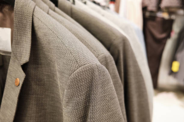 istock Men casual jackets hang on coathangers at showroom 1288901912
