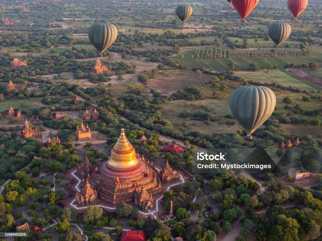 Dhammayazika Pagoda Temple and hot air balloons in Myanmar Horizontal shot, Sunrise flight Myanmar Stock Photo