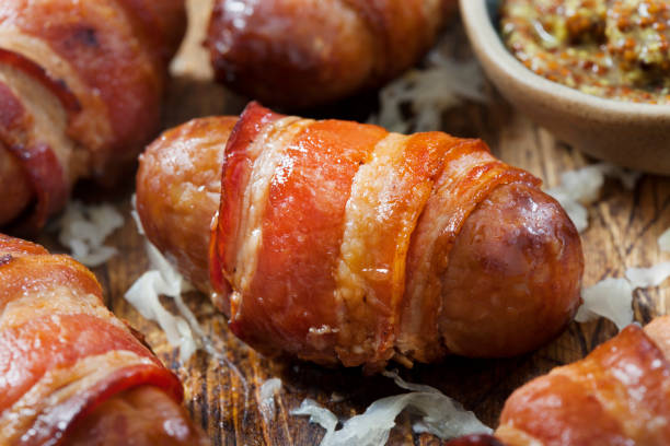 istock Mini Bacon Wrapped Bratwurst Sausages with  Sauerkraut and Grainy Mustard 1288905616