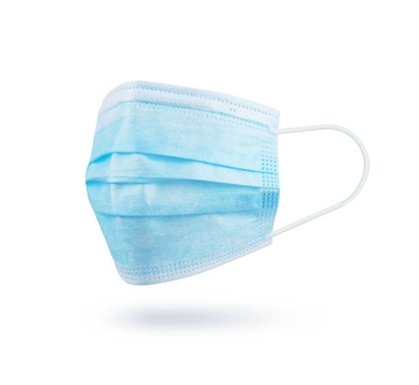 istock Blue medical protective mask, isolated on white background. 1288906306