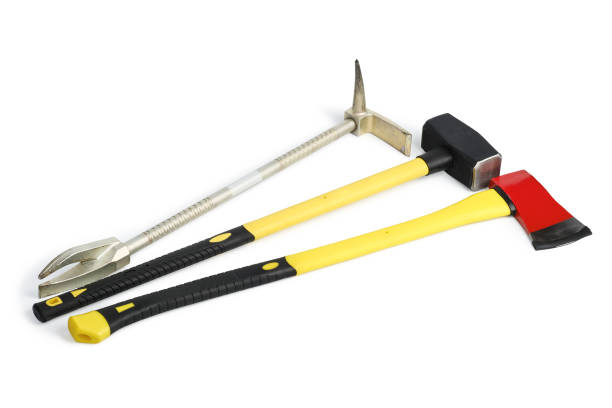 Large yellow sledgehammer, axe and hooligan pinch-bar from firefighter's toolbox isolated on white background with clipping path