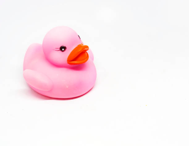 istock Pink rubber duck with orange beak isolated on a white background. 1288909182