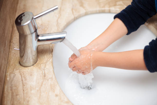 istock Young kid washing hands under the tap water 1288909470