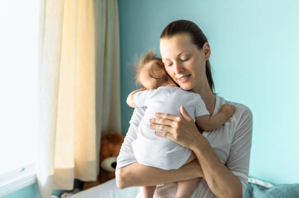 istock Mother holding sleeping baby 1288911318