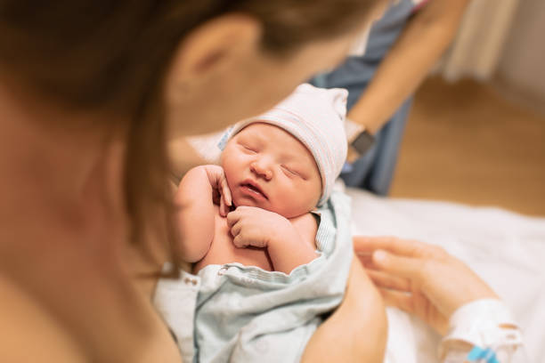 istock First time mom holding her newborn baby 1288911536