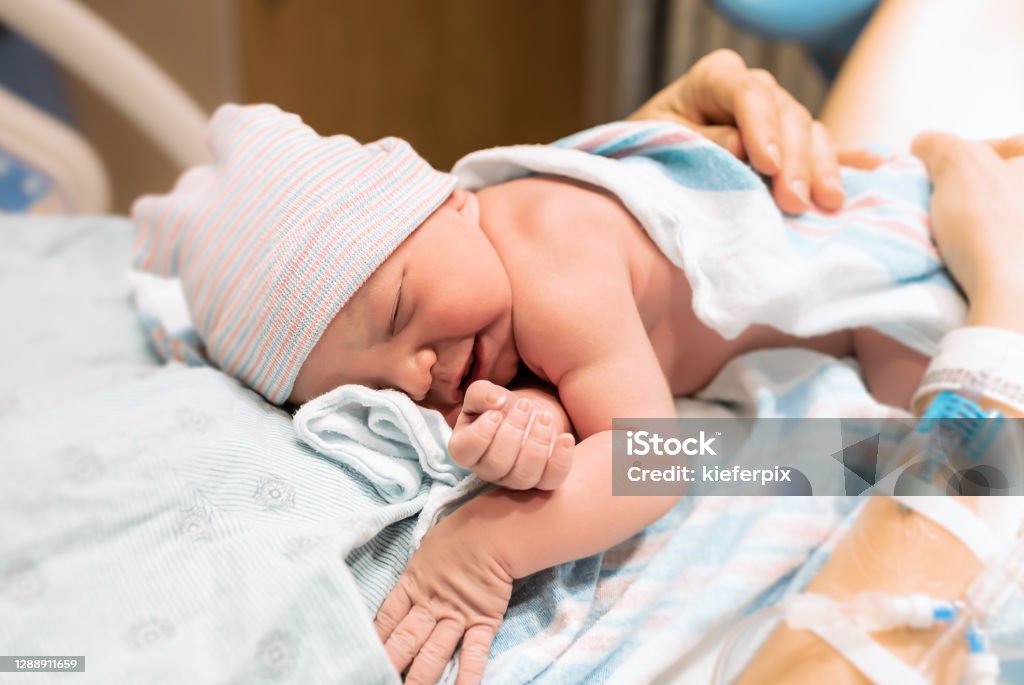 Mother holding her newborn baby in the hospital Newborn baby, Child delivery. Newborn Stock Photo