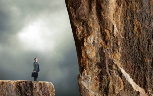 istock Businessman Looks Up At Daunting Task 1288912498