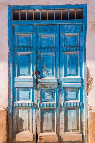 istock Old rustic door and stucco facade in Huaraz – Ancash province, Peru 1288915805